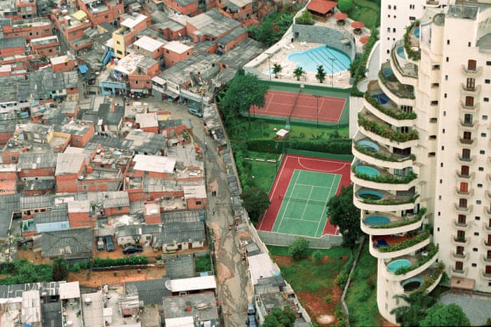 Picture taken by photographer Tuca Vieira in Brazil (2004). This contrasts the poverty of Paraisópolis favela (left) with its wealthy neighbor, Morumbi (right). 